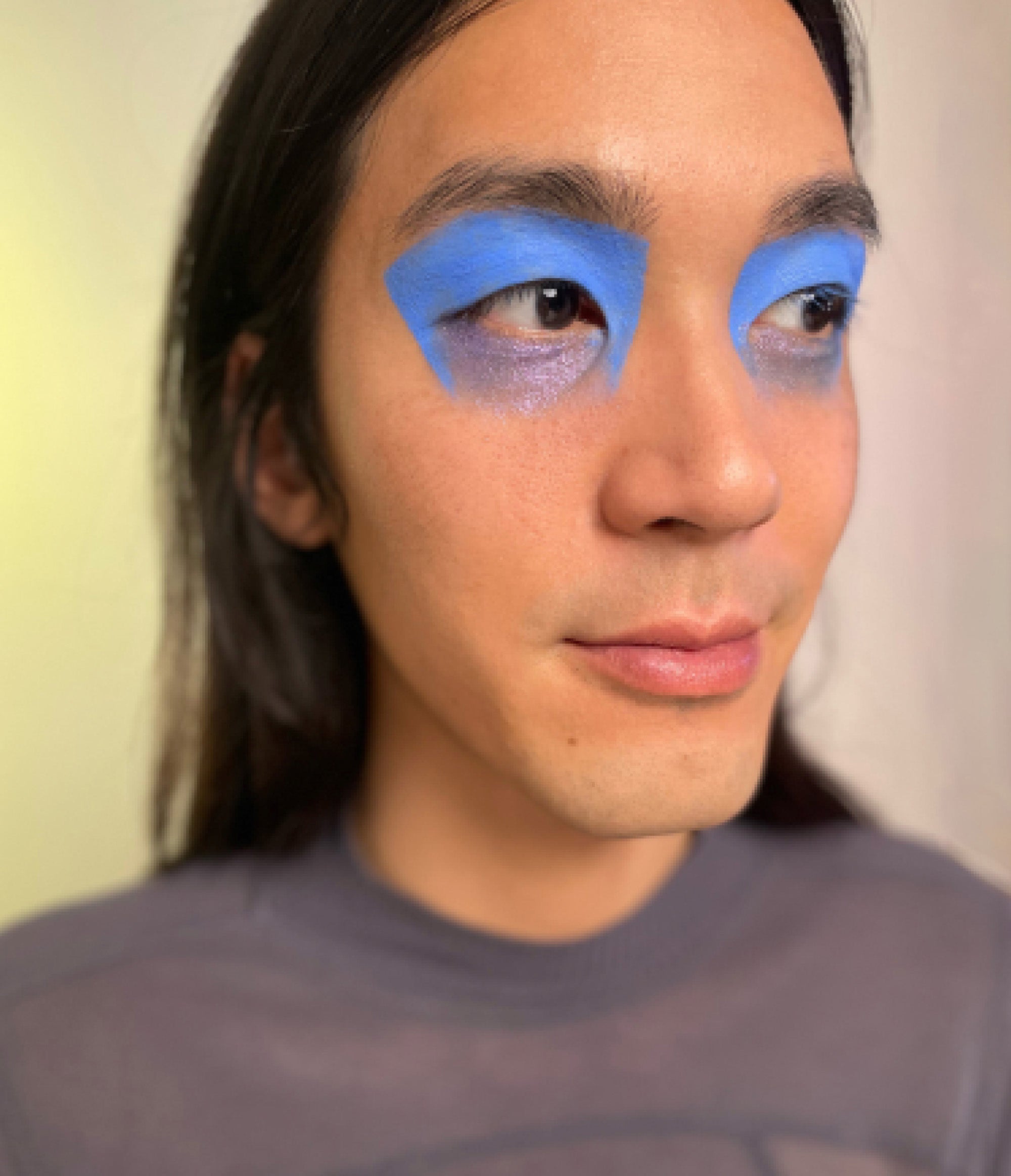 Model with medium skin tone wearing Deepdive in Benitoite over eye area.