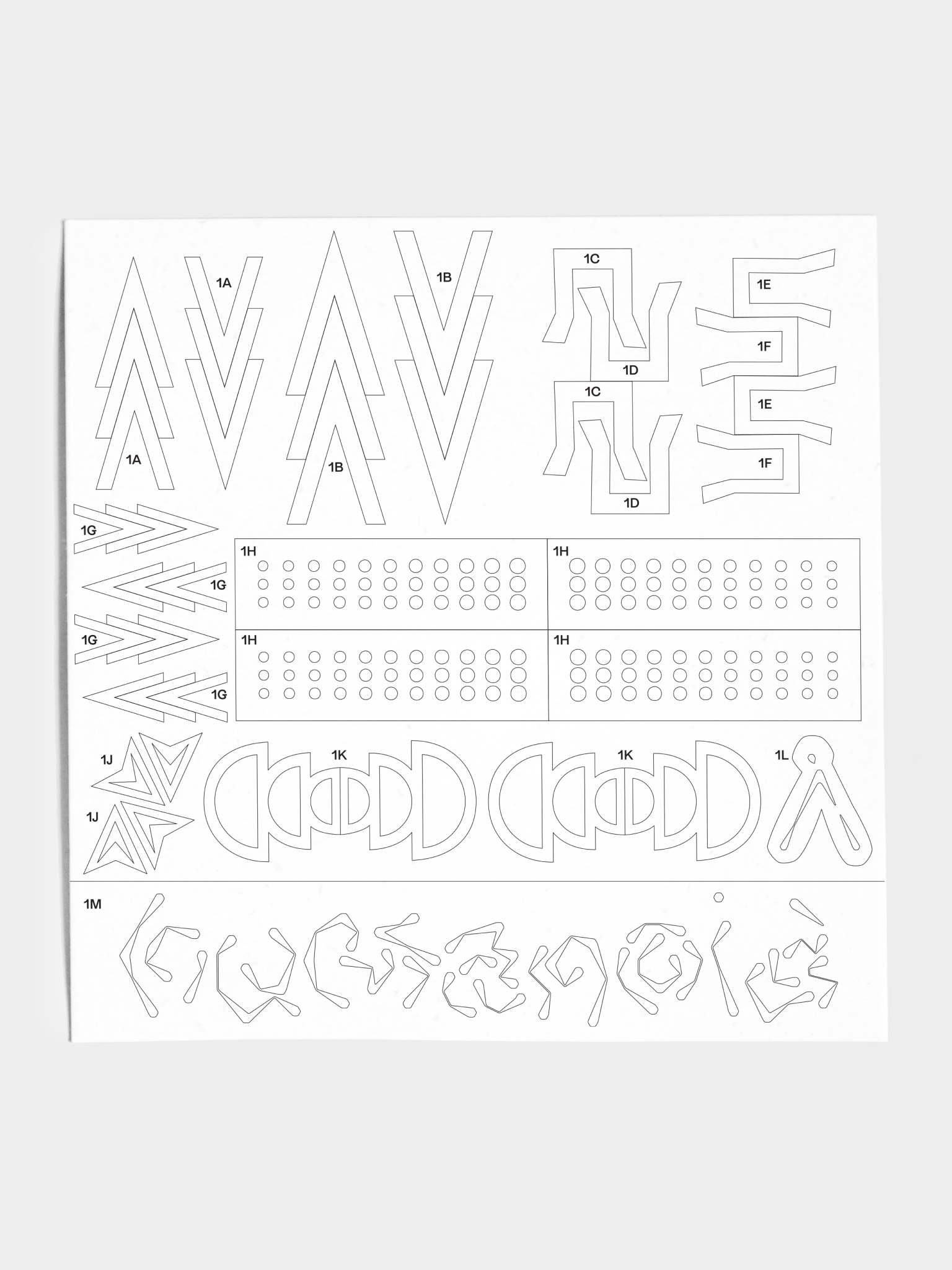 Close up of stencil sheet with various geometric shapes and dots.