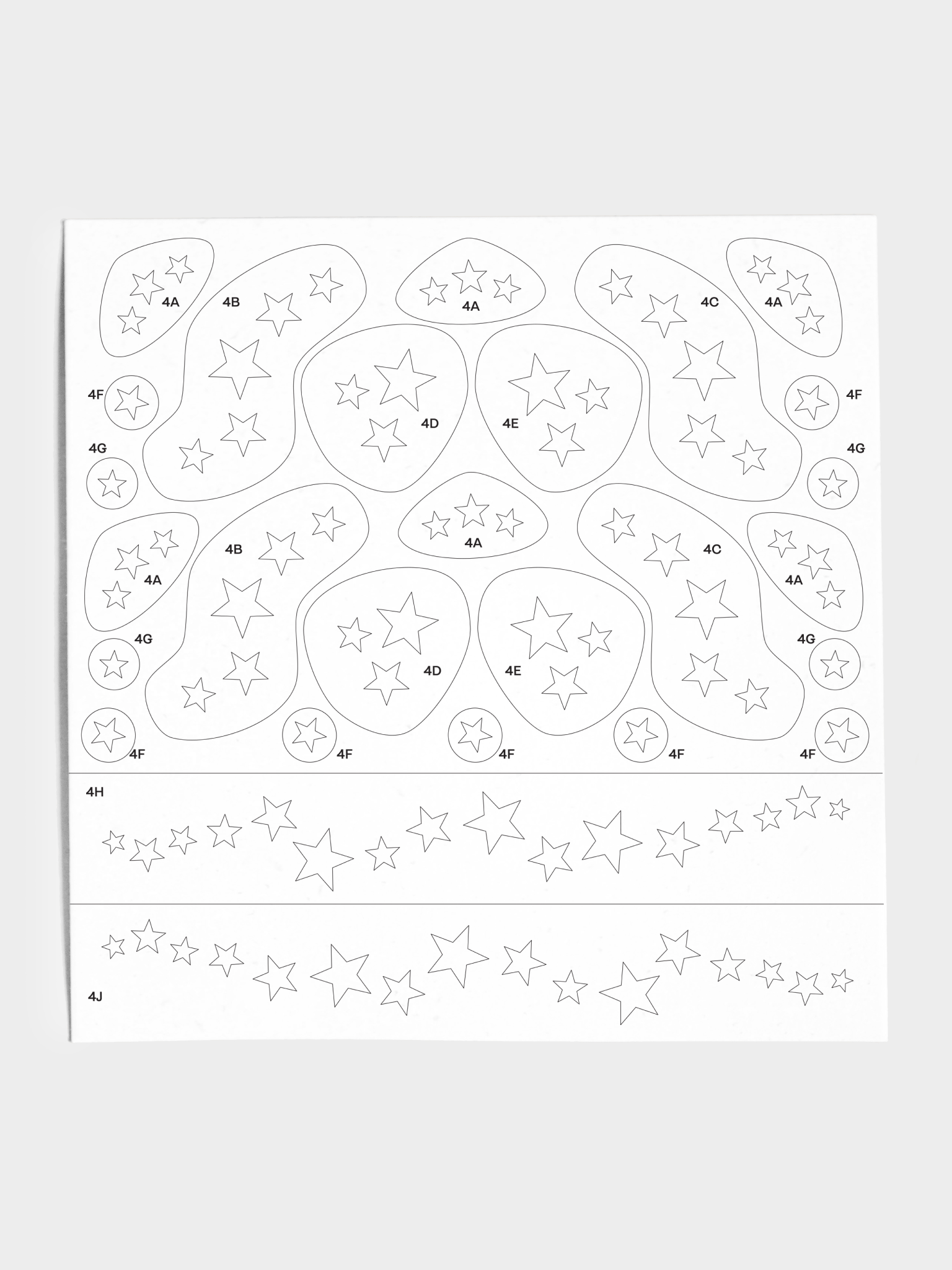 Closeup of stencil sheet with various star patterns