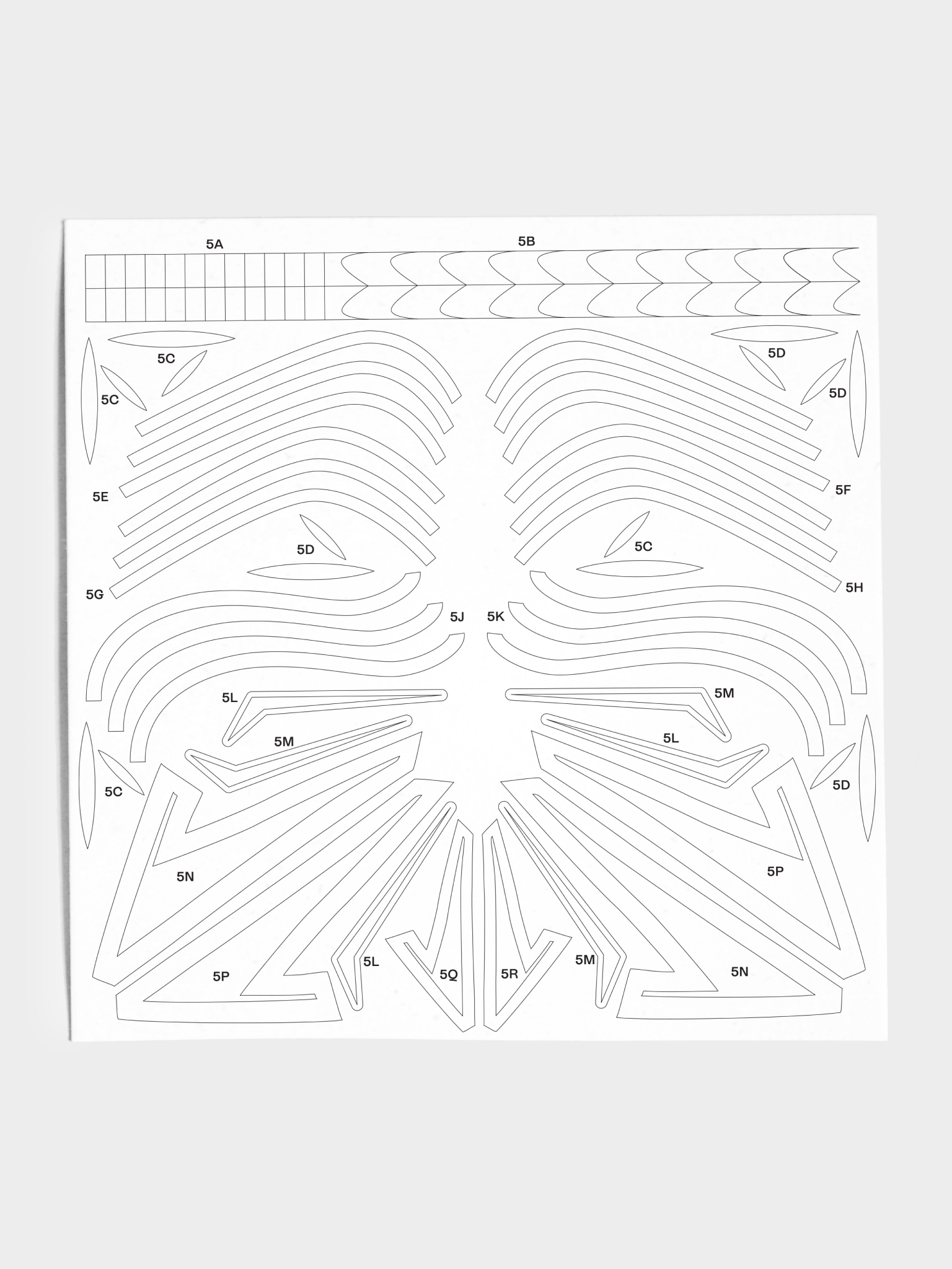 Closeup of stencil sheet with various arches and shapes.