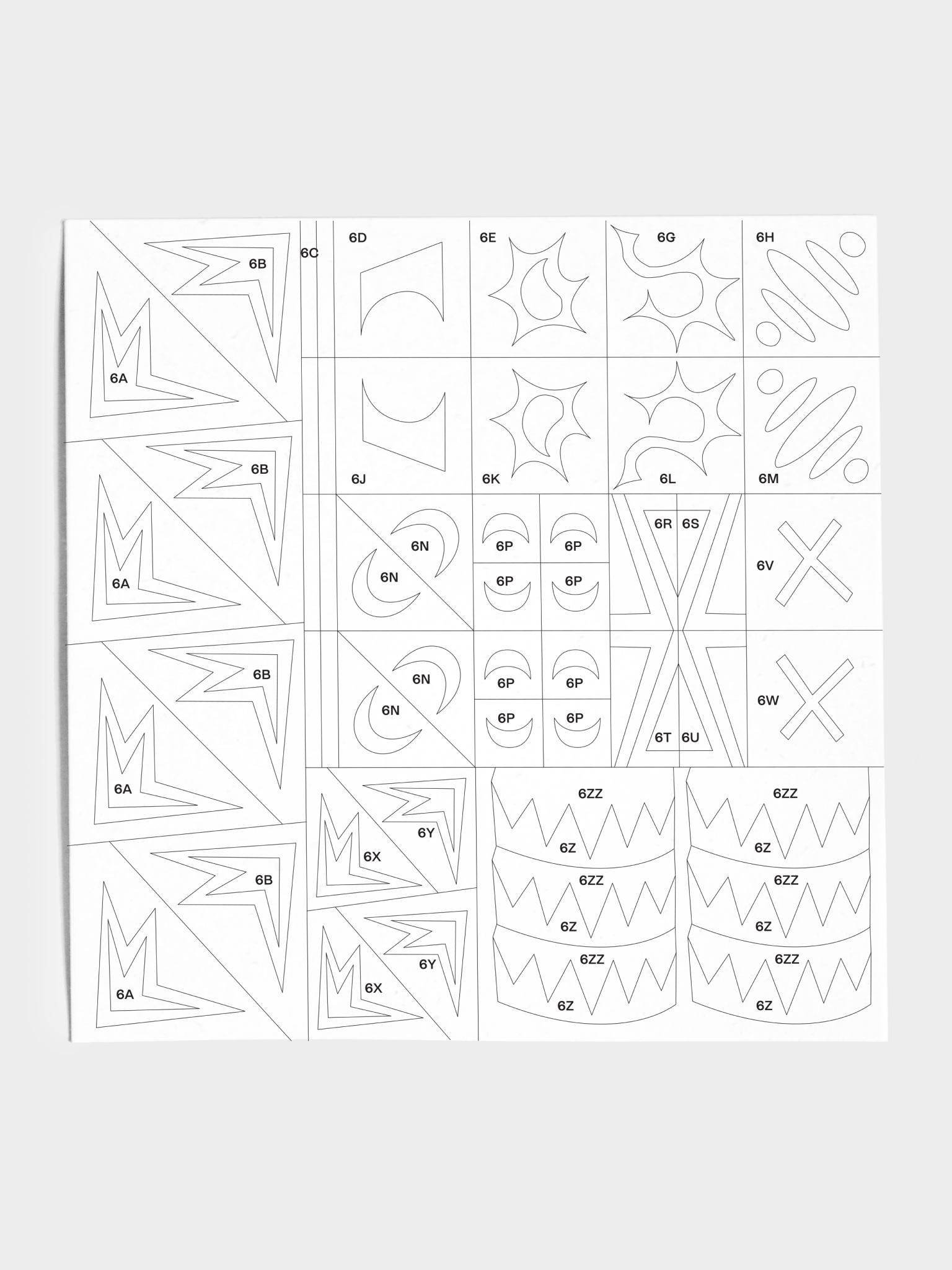 Closeup of stencil sheet with various geometric shapes, starbursts, x's, and zigzags